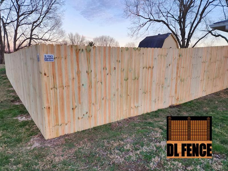 Wood privacy fence wrapping yard corner in Southport, IN