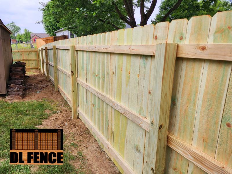 Wood privacy fence wrapping yard corner in Shelbyville, IN