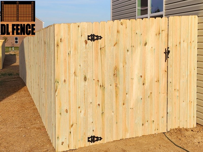 Straight-line privacy fence with heavy-duty black hinges and latches. Built by DL Fence for secure yard enclosure – 800x600