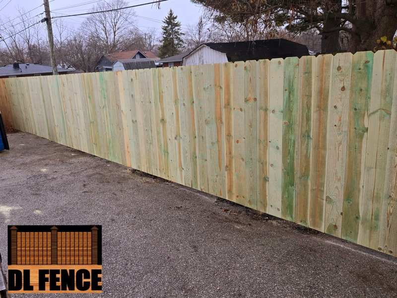 Long run of reinforced wood pickets for complete privacy, professionally installed by DL Fence in a residential alley – 800x600