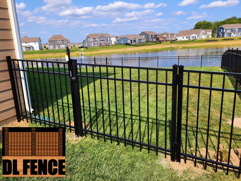 Black aluminum fence enclosing a scenic lakeside residential property. Clean lines and premium quality from DL Fence – 800x600