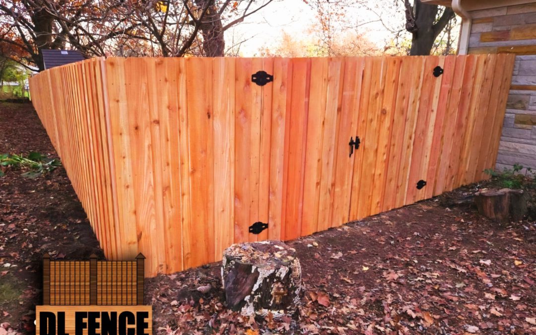 Angled wood privacy fence with black gate hardware by DL Fence in Central Indiana